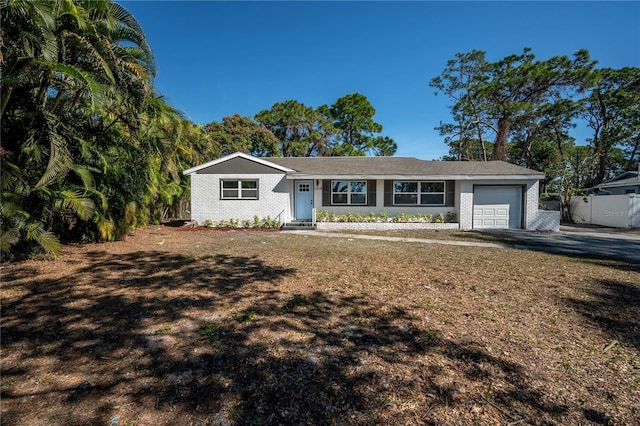 single story home with a garage and a front lawn