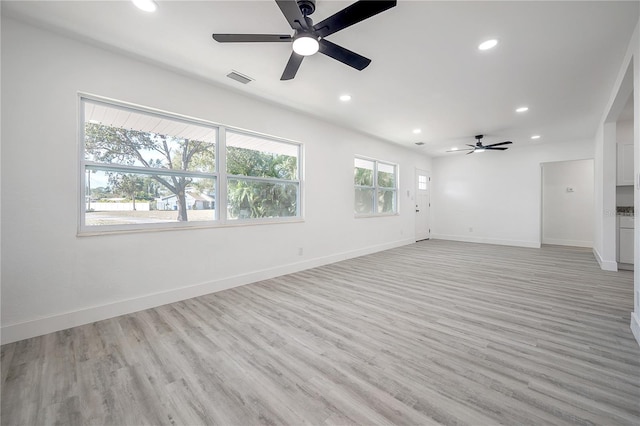 unfurnished living room with ceiling fan and light hardwood / wood-style floors