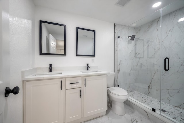 bathroom featuring vanity, toilet, and a shower with door