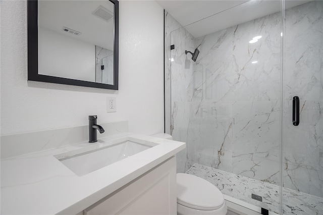 bathroom with vanity, an enclosed shower, and toilet