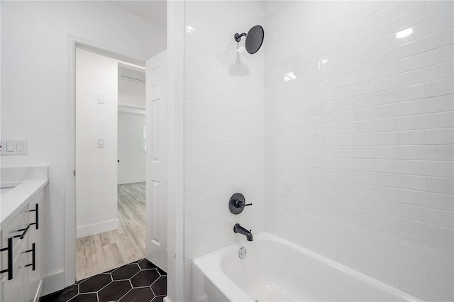 bathroom featuring vanity, tiled shower / bath combo, and tile patterned floors