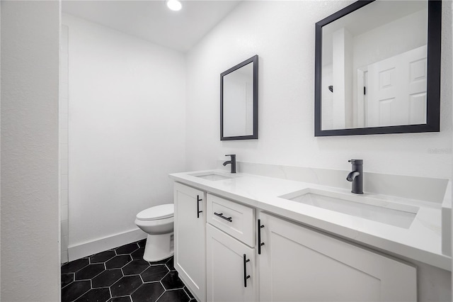 bathroom with vanity, toilet, and tile patterned flooring