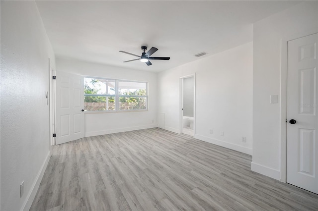 empty room with ceiling fan and light hardwood / wood-style flooring