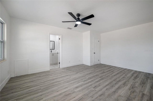 unfurnished room with a wealth of natural light, light hardwood / wood-style flooring, and ceiling fan