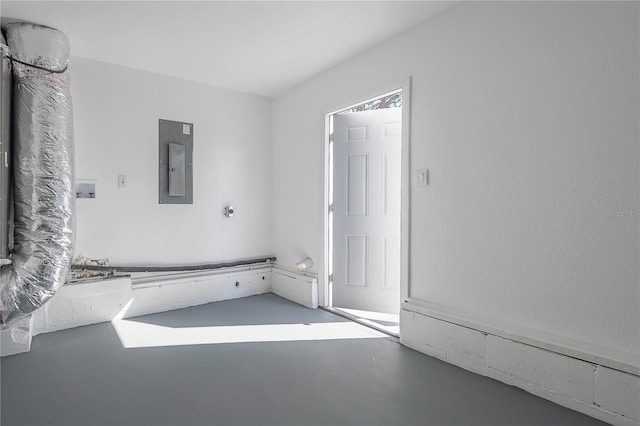 bathroom featuring electric panel and concrete floors