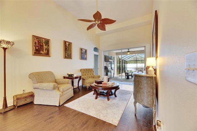 living room with wood-type flooring and ceiling fan