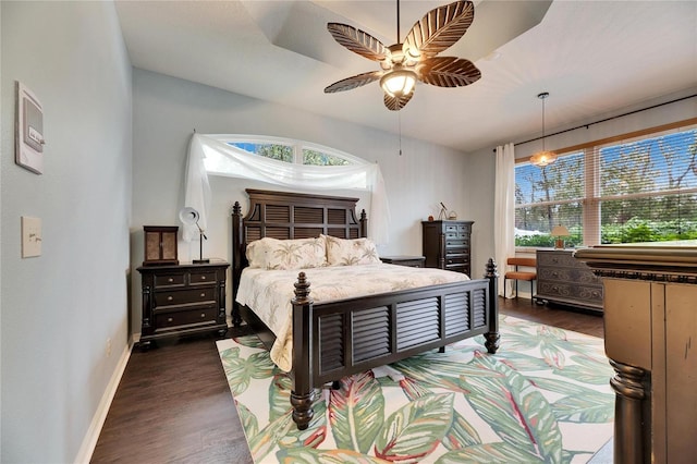 bedroom with ceiling fan and dark hardwood / wood-style floors