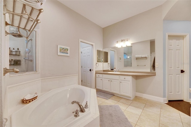 bathroom with tile patterned floors, vanity, and shower with separate bathtub