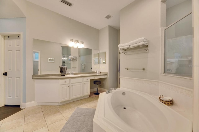 bathroom with plus walk in shower, vanity, and tile patterned flooring