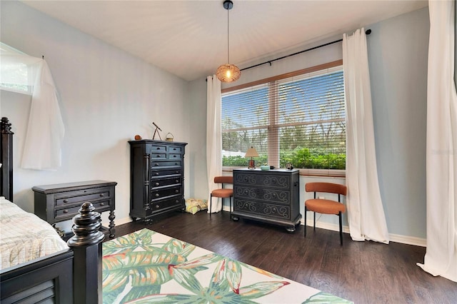 bedroom with dark wood-type flooring