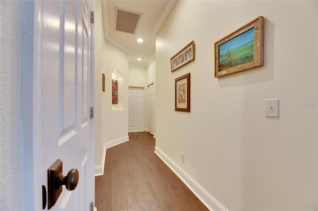 hallway featuring crown molding and dark hardwood / wood-style floors