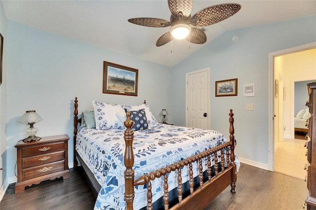 bedroom with dark wood-type flooring, vaulted ceiling, and ceiling fan