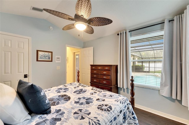 bedroom with ceiling fan, dark hardwood / wood-style floors, and vaulted ceiling