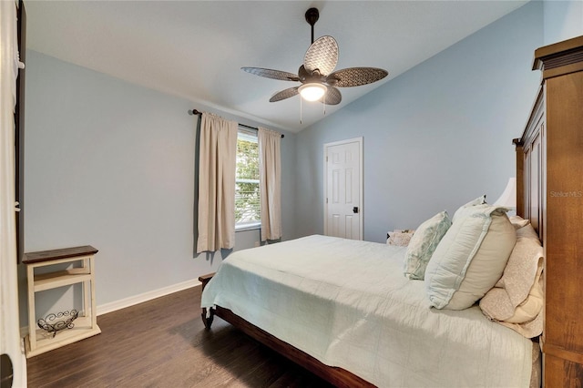 bedroom featuring lofted ceiling, dark wood-type flooring, and ceiling fan