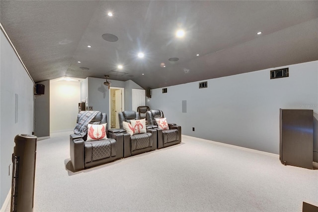 carpeted home theater featuring lofted ceiling