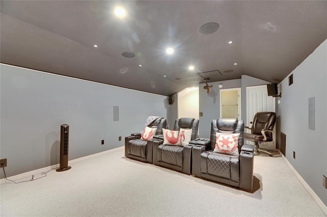 cinema room featuring light carpet and vaulted ceiling