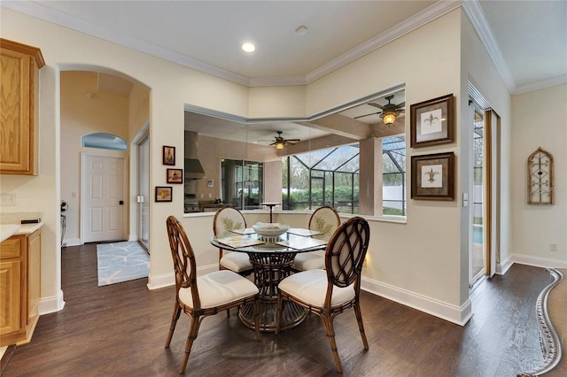 dining space with dark wood-type flooring, a wealth of natural light, and ornamental molding