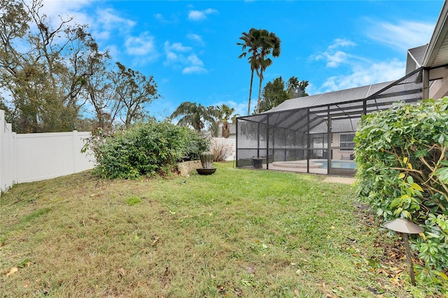 view of yard featuring a lanai and a swimming pool