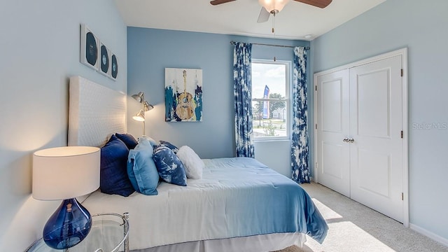 carpeted bedroom featuring a closet and ceiling fan