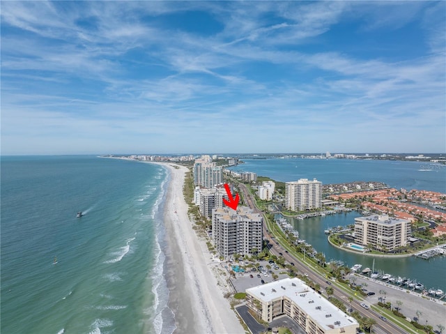 bird's eye view featuring a water view and a beach view