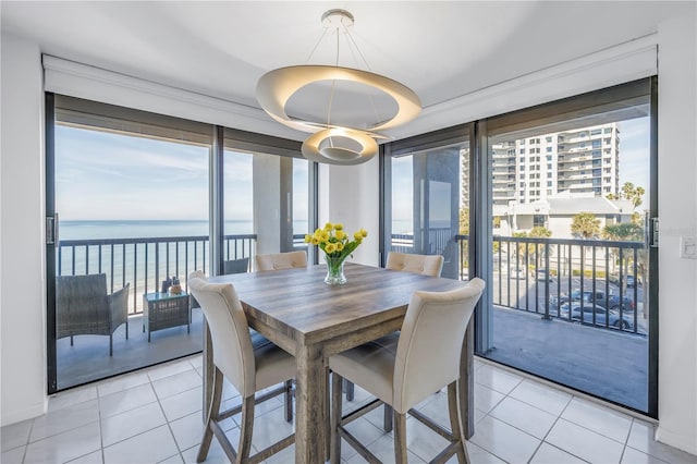 tiled dining space with a water view and a wealth of natural light