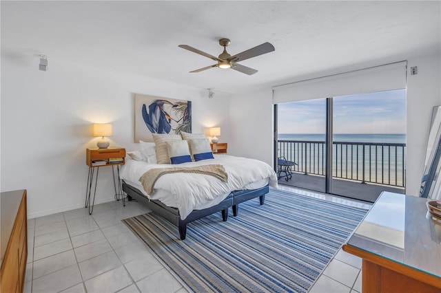 tiled bedroom with a water view, access to outside, and ceiling fan