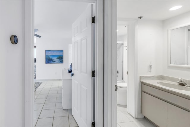 bathroom featuring tile patterned flooring, vanity, and toilet