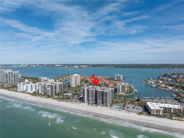 birds eye view of property with a view of the beach and a water view