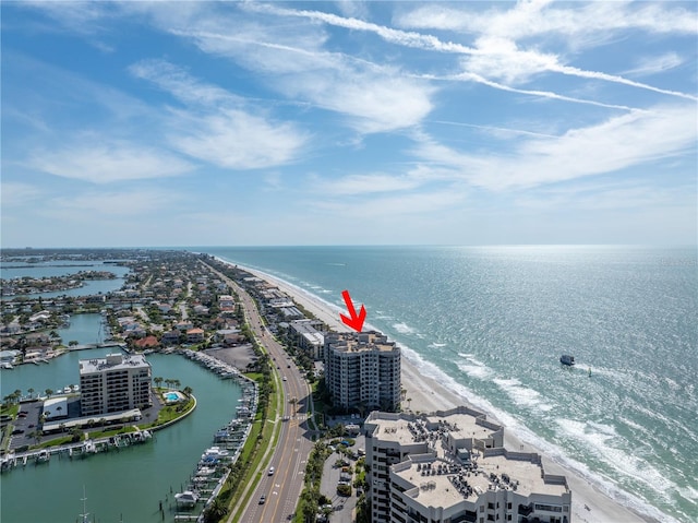 bird's eye view with a water view and a beach view