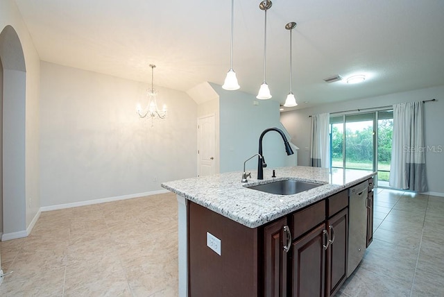 kitchen with pendant lighting, sink, a kitchen island with sink, stainless steel dishwasher, and light stone countertops