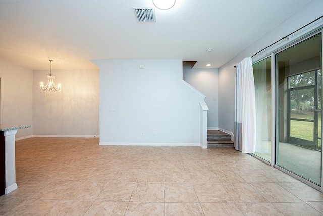 spare room with a notable chandelier