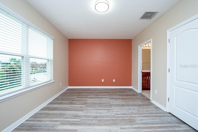 spare room with light hardwood / wood-style floors