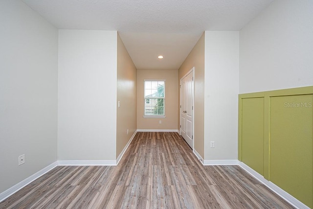 hall with light hardwood / wood-style floors