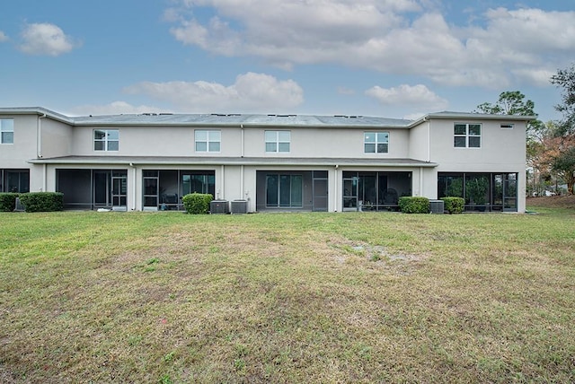 rear view of property with a yard and cooling unit