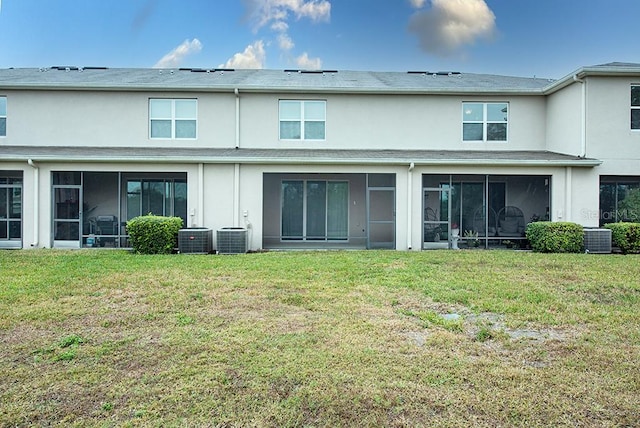 rear view of house with a yard and central air condition unit