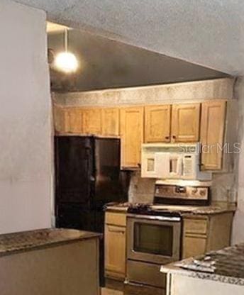 kitchen featuring black refrigerator, stainless steel electric range oven, and a textured ceiling