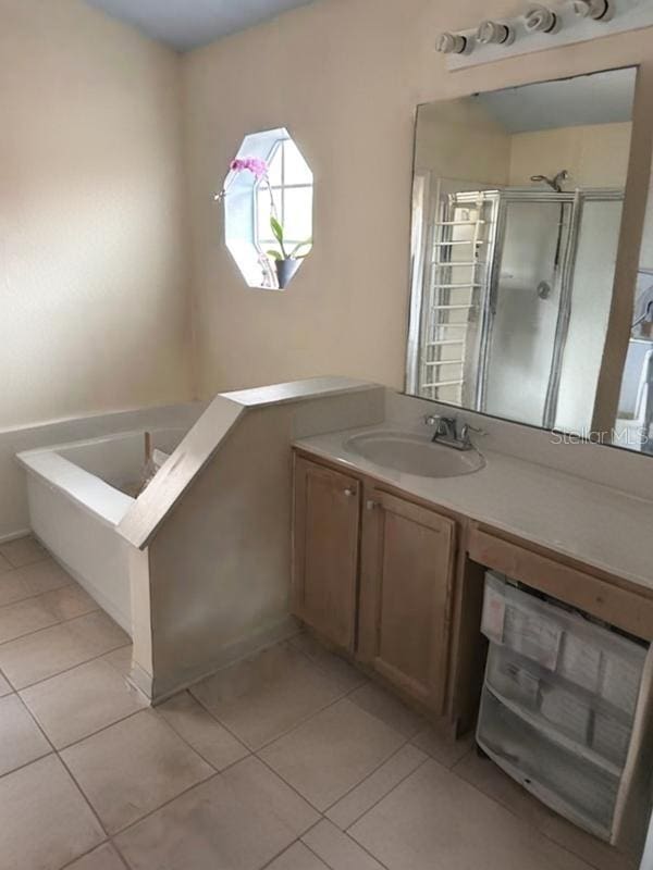 bathroom with vanity, shower with separate bathtub, and tile patterned floors