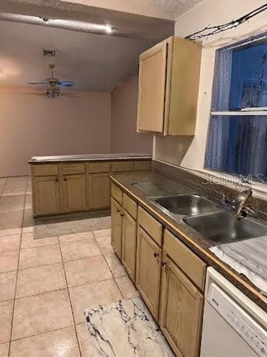 kitchen featuring sink, light tile patterned floors, dishwasher, ceiling fan, and a textured ceiling