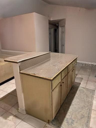 kitchen featuring light tile patterned flooring and a center island