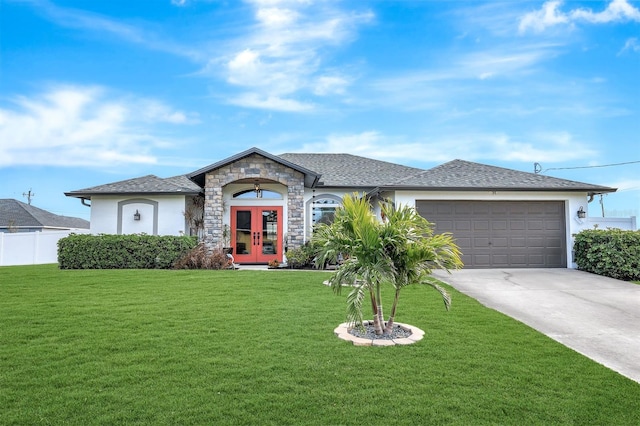 ranch-style home with a garage, a front yard, and french doors