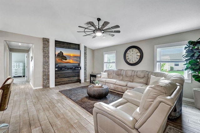 living room with light hardwood / wood-style floors and ceiling fan