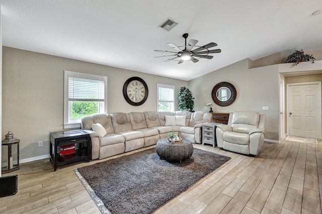 living room featuring ceiling fan and vaulted ceiling