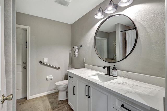 bathroom with toilet and vanity