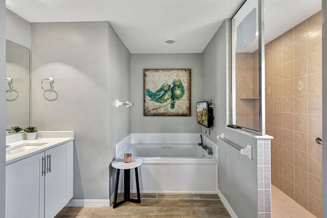 bathroom featuring vanity and separate shower and tub