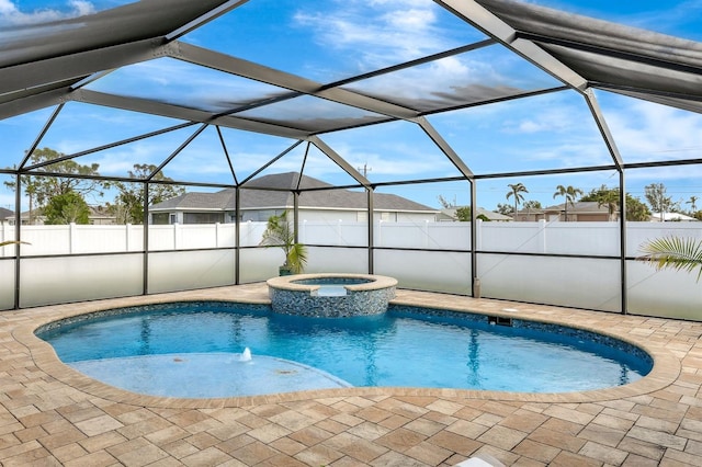 view of pool featuring an in ground hot tub, glass enclosure, and a patio area