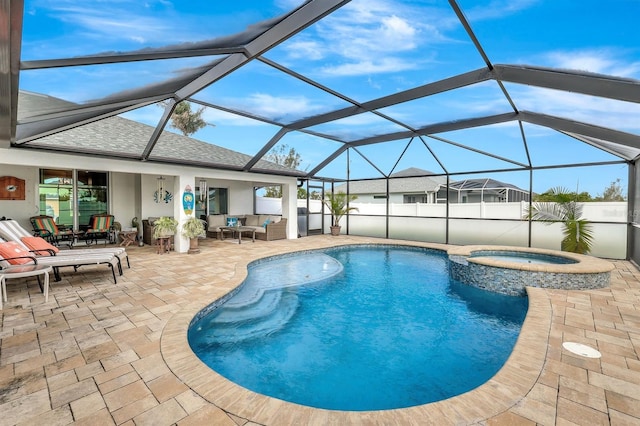 view of pool with an in ground hot tub, a patio area, glass enclosure, and an outdoor hangout area