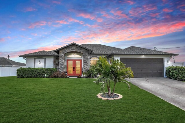 3105 SW 16th Pl, Cape Coral, FL 33914 - view of front facade featuring driveway, french doors, a front lawn, and stucco siding