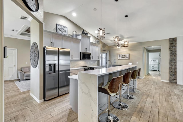 3105 SW 16th Pl, Cape Coral, FL 33914 - kitchen featuring ceiling fan, light wood finished floors, stainless steel appliances, visible vents, and a center island with sink