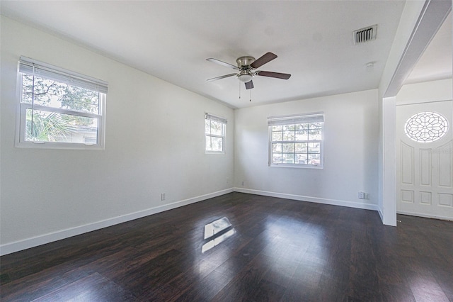 spare room featuring dark hardwood / wood-style floors and ceiling fan