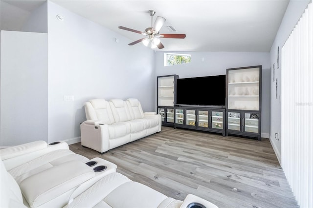 living room with vaulted ceiling, ceiling fan, and light wood-type flooring